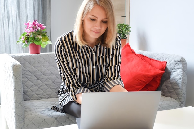 businesswoman working on laptop thinks at work distance work and training