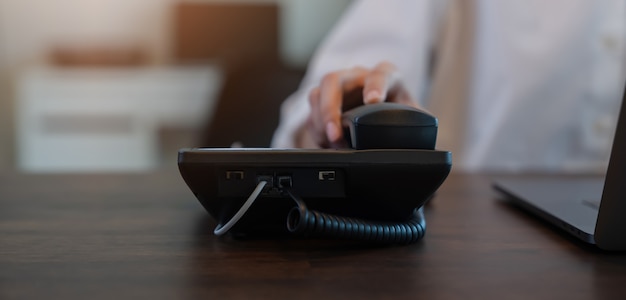 Businesswoman working on office phone handle and call center and customer service help desk.