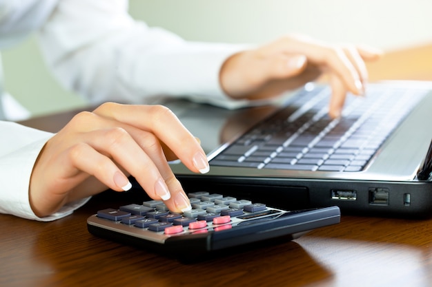 Businesswoman working in the office with items for doing business