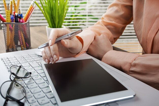 Businesswoman working in the office with items for doing business