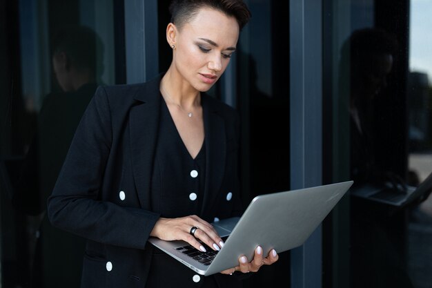 Businesswoman working outdoors with laptop