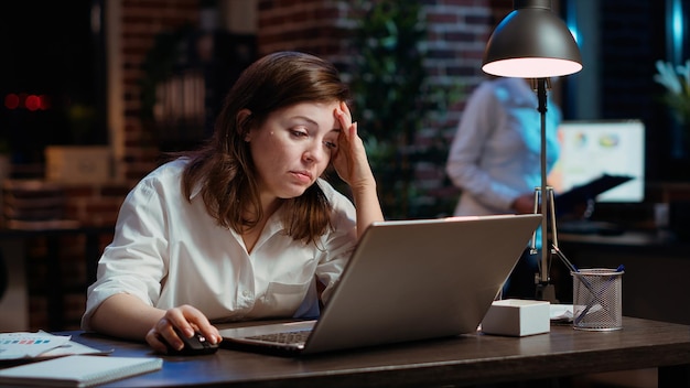 businesswoman working overtime for company project doing tasks in office