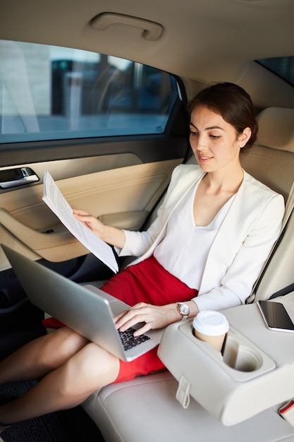 Businesswoman Working in Taxi