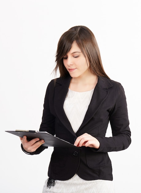 Businesswoman working with clipboard 