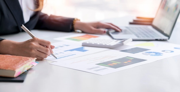 Businesswoman working with document on her desk planning analyzing the financial report