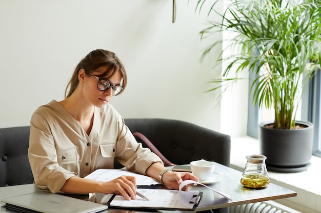 Businesswoman working with report