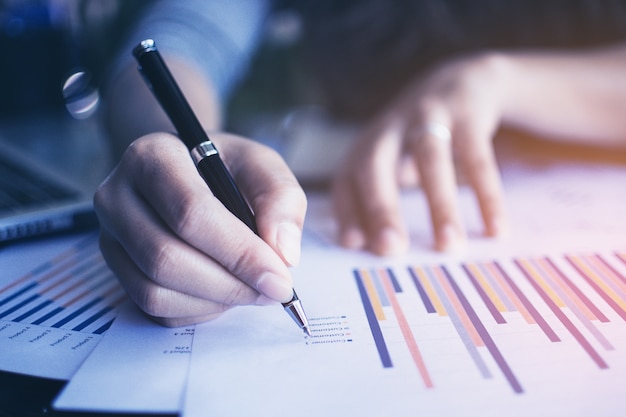 Businesswoman working with sheet analysis charts