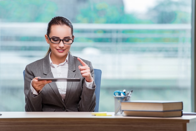 Businesswoman working with tablet computer in business concept