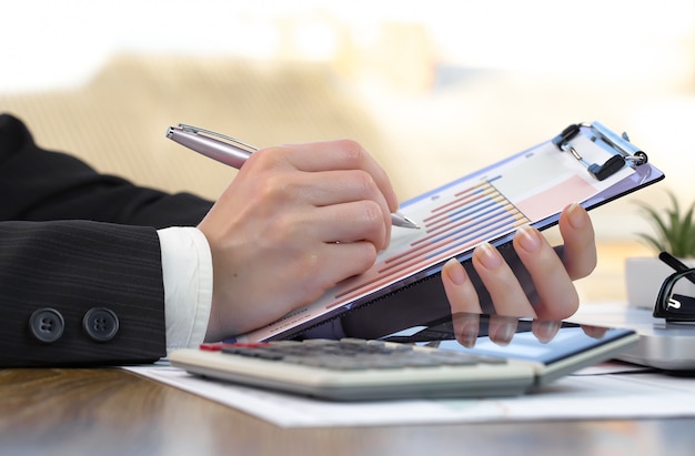 Businesswoman works in office with items for doing business.