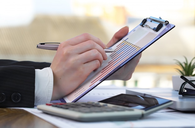 Businesswoman works in office with items for doing business.