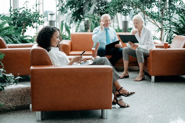 Businesswoman works sitting in the spacious lobby of the business center