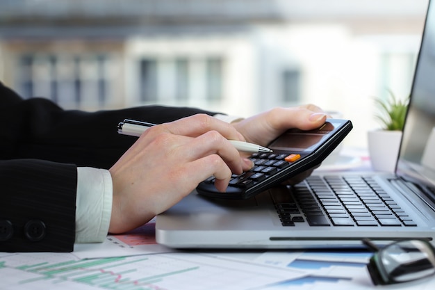 Businesswoman works with items for doing business in the office.