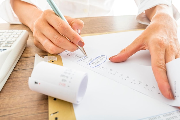 Businesswoman Works with Receipts at her Desk