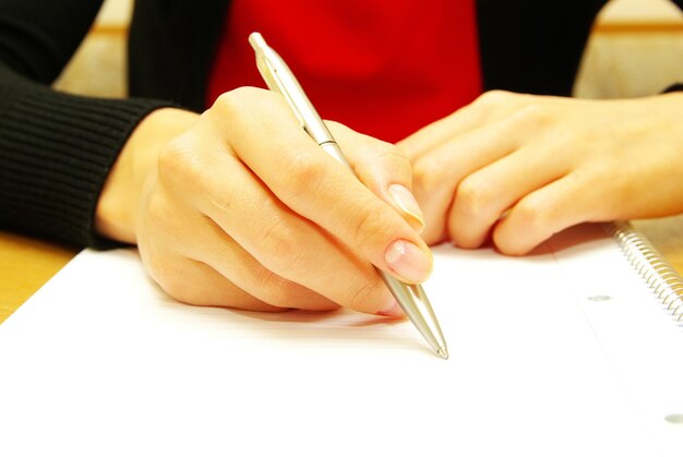 Businesswoman writes a pen on an empty paper