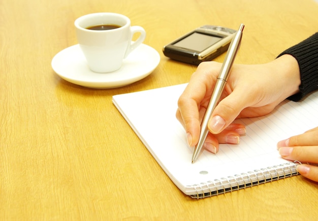 Businesswoman writes a pen on an empty paper