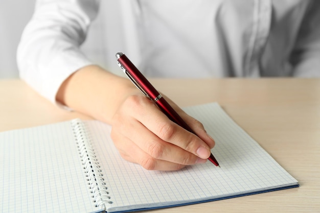 Businesswoman writing on document