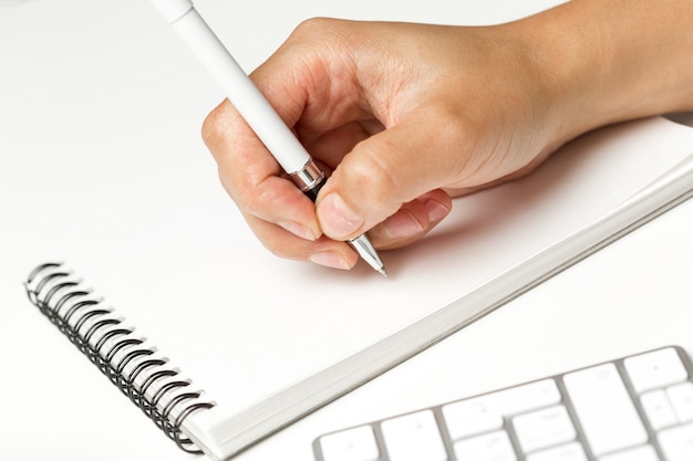 Businesswoman writing in notepad