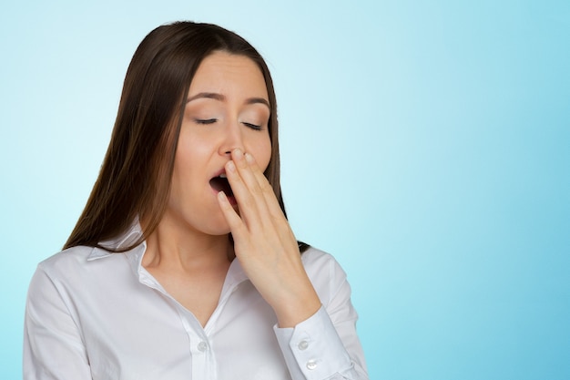 Businesswoman yawning isolated