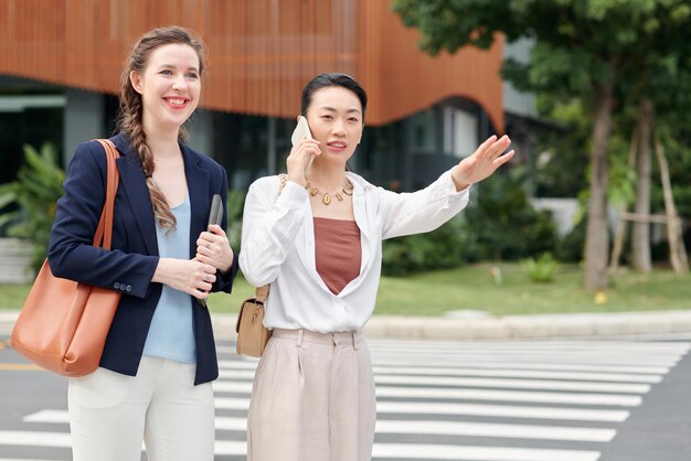 Businesswomen catching taxi