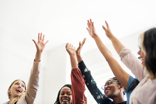 Businesswomen putting hands in the middle