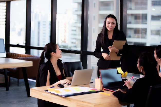 Businesswomen smiling and Discussing with colleague in meeting