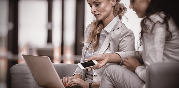 Businesswomen using laptop