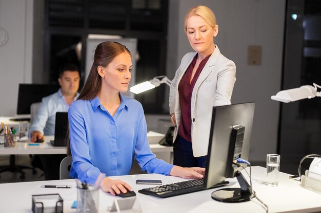 businesswomen with computer working late at office