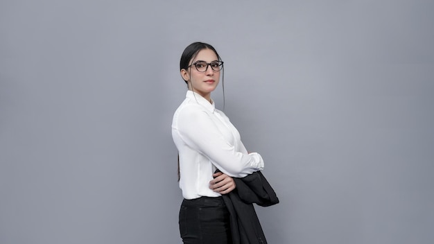 businesswomen with glasses holding black coat looking left wearing white shirt indian pakistan