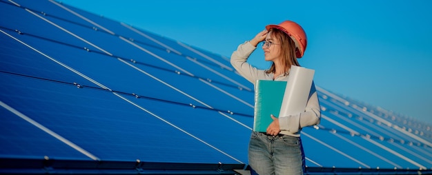 Businesswomen working on checking equipment at solar power plant with tablet checklist, woman working on outdoor at solar power plant.