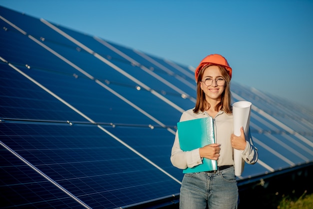 Businesswomen working on checking equipment at solar power plant with tablet checklist, woman working on outdoor at solar power plant.