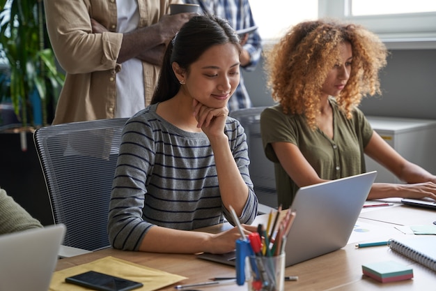 Businesswomen writing graphs and charts for statements