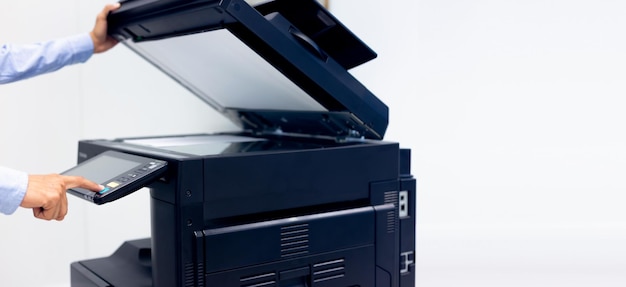 Bussiness man hand press button on panel of printer printer
scanner laser in office copy machine supplies start concept