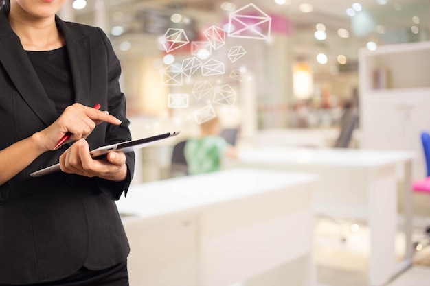 Bussiness women sending email In office room