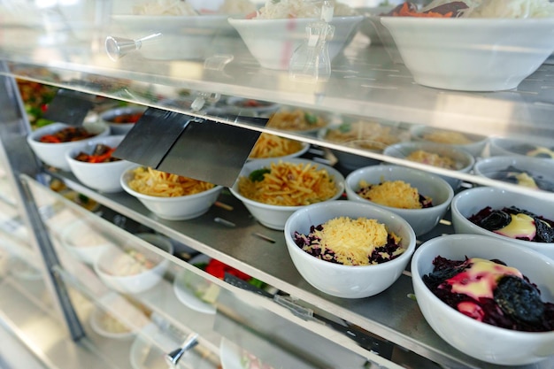 Bustling cafeteria serving line during lunchtime offering a variety of dishes