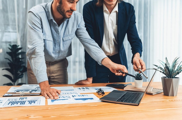 Busy analyst team in office analyzing financial data analysis Entity