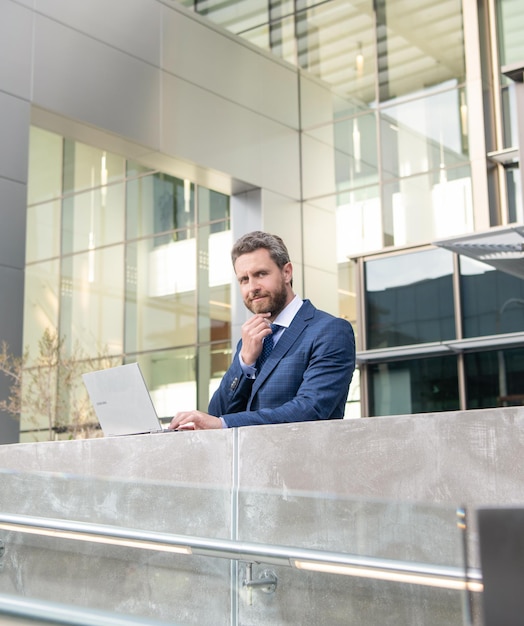 Busy business man in formalwear work online on computer outdoor agile business