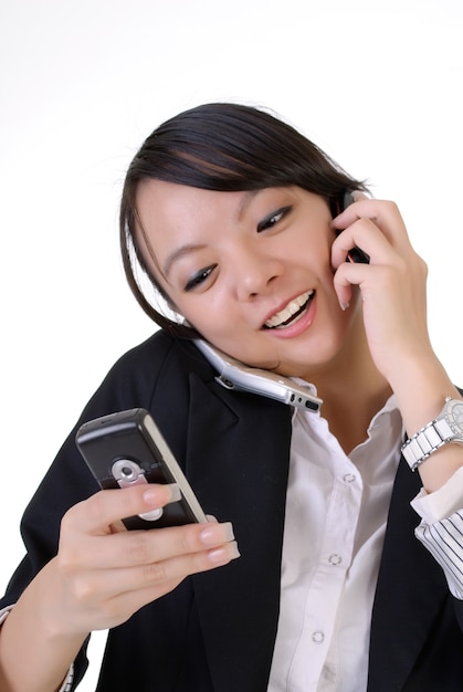 Busy business woman with smiling expression talking on cellphone.