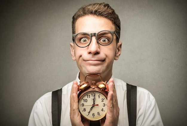 Busy businessman holding a clock