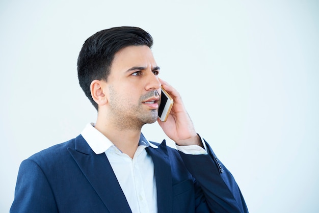 Busy businessman with mobile phone