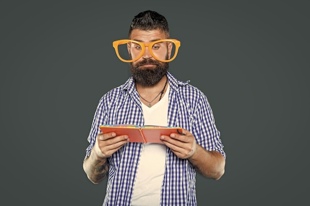 Photo busy funny bearded man in party glasses read book