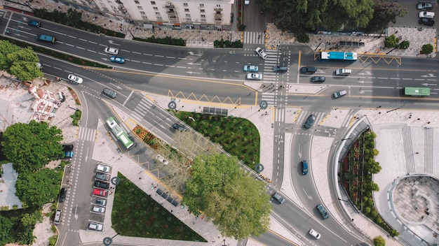 A busy intersection with a road that has a sign that says " no parking ".