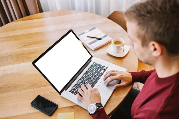 A busy man is paying bills online on the laptop