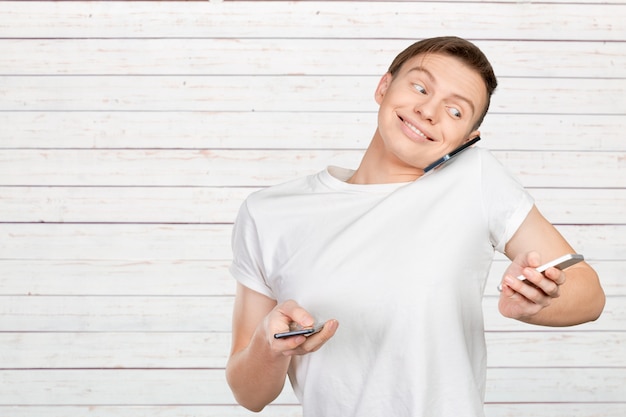 Busy man talking several phones same time