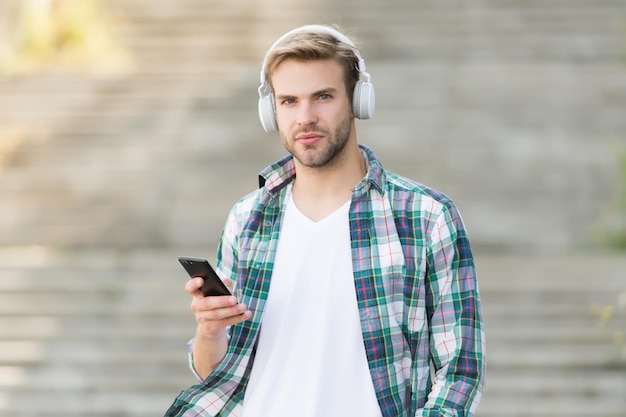 Busy man wireless headphones use smartphone download application concept