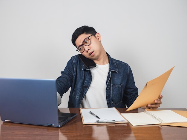 Busy man working hard at his workspace