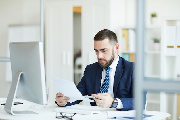 Busy manager examining contract