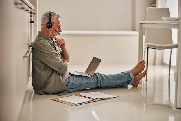 Busy senior man working remotely from his home