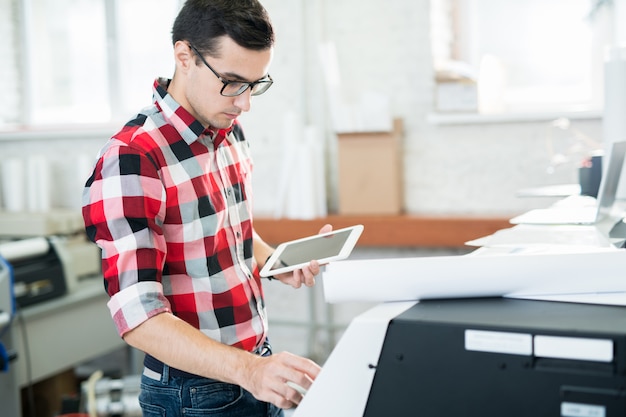 Busy technician working with printer