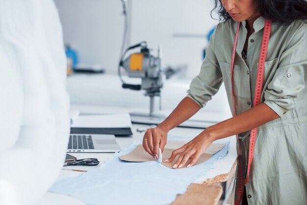 busy with cloth. female worker is in the sewing factory.