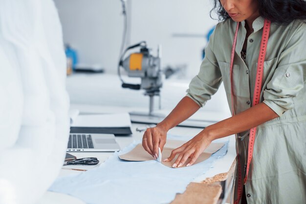 Photo busy with cloth. female worker is in the sewing factory.